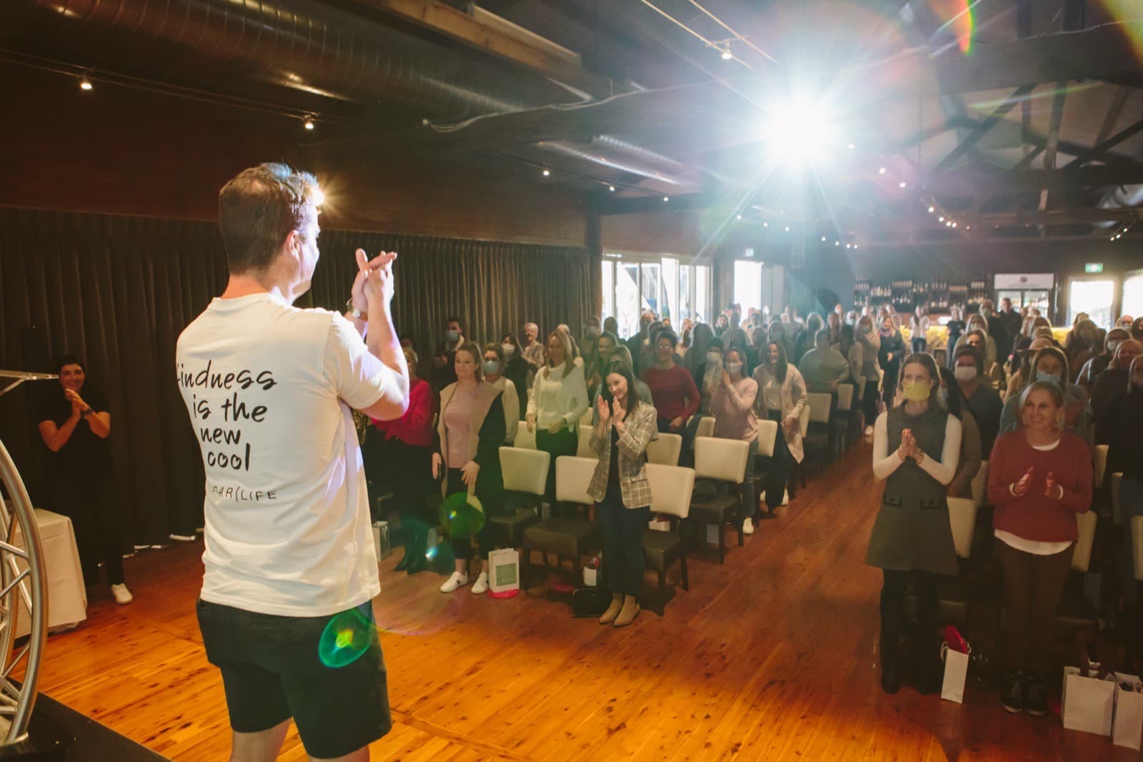 Dale Sidebottom on stage in front of a full audience of educators