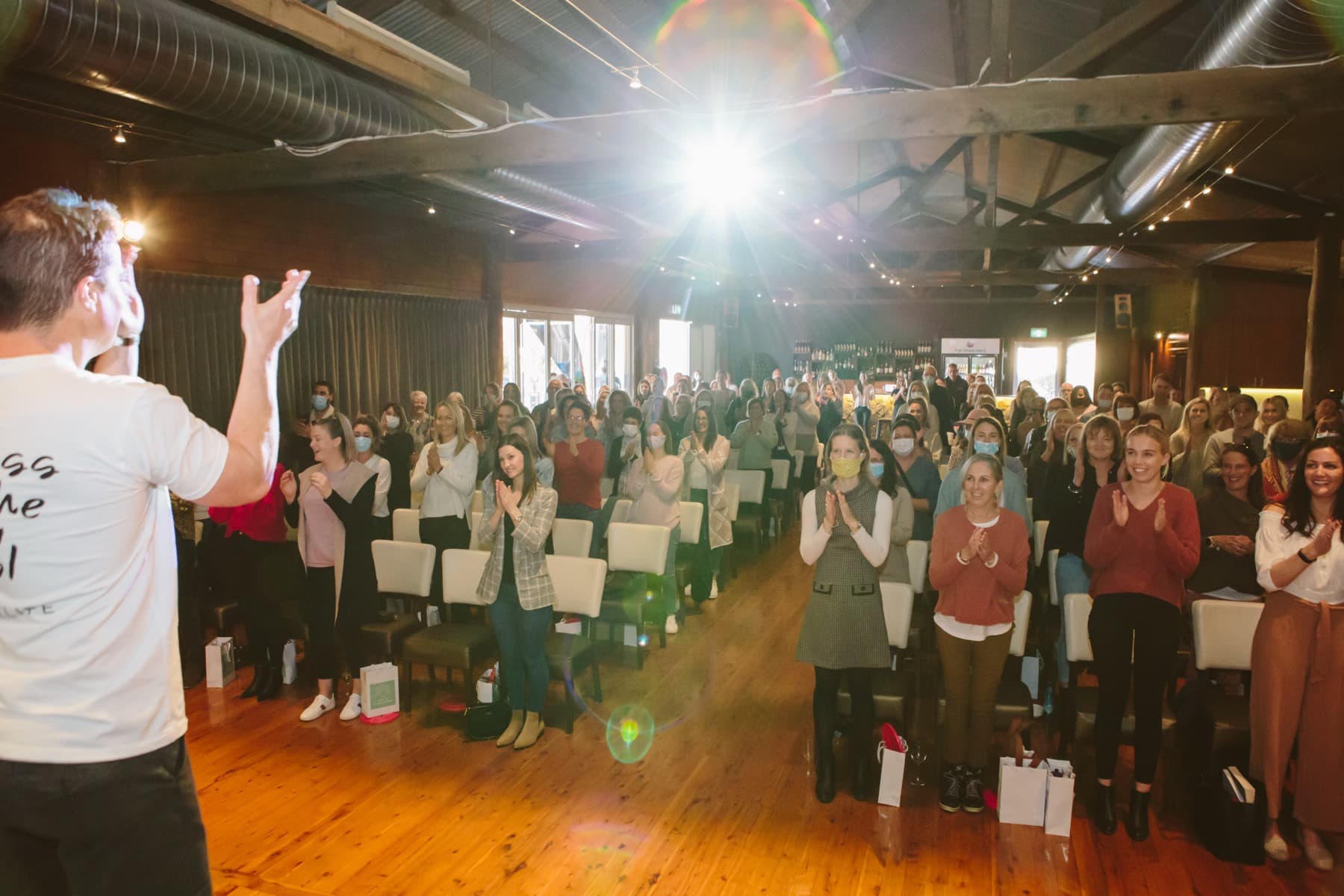 A packed room of educators applauding at a School of Play leadership event
