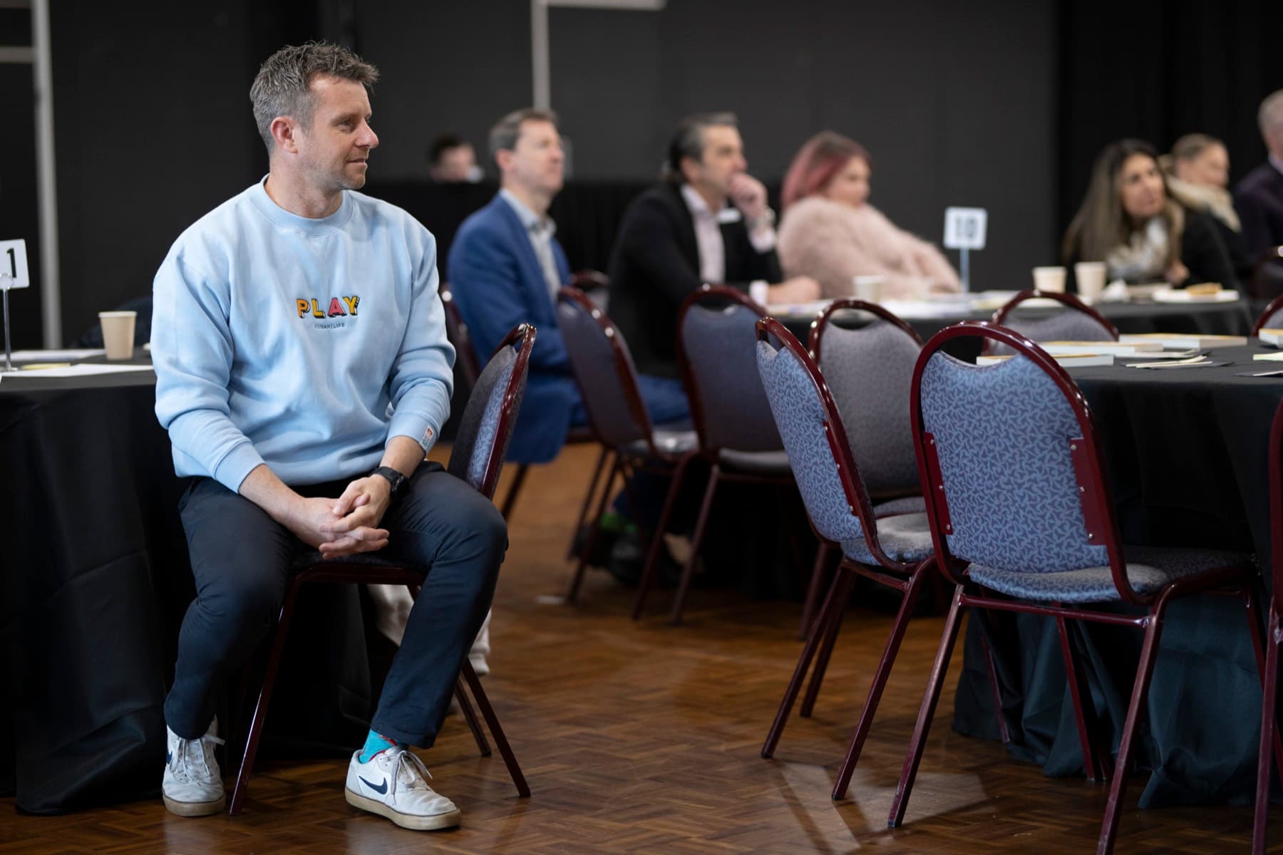 A leader listening intently among workshop participants