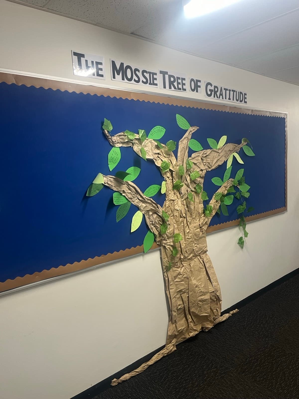 A paper gratitude tree titled The Mossie Tree of Gratitude on a school corridor wall at Mossgiel Park Primary